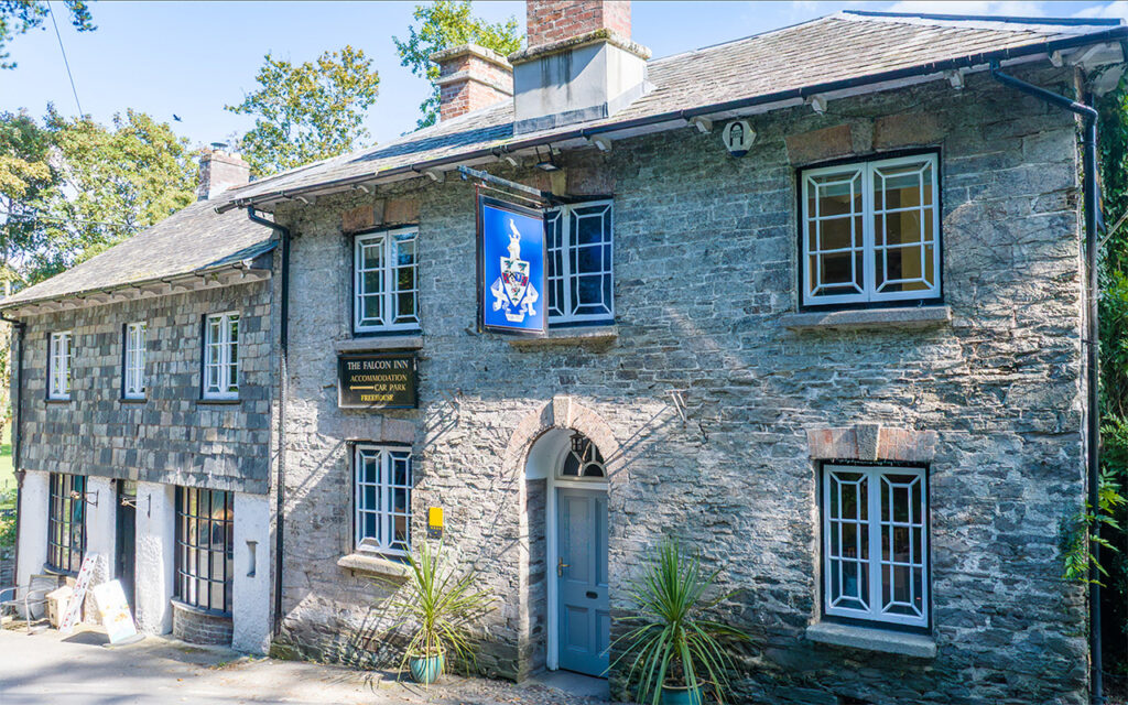 The Falcon Inn The Falcon Inn stone building with sign. Accommodation and car park free.